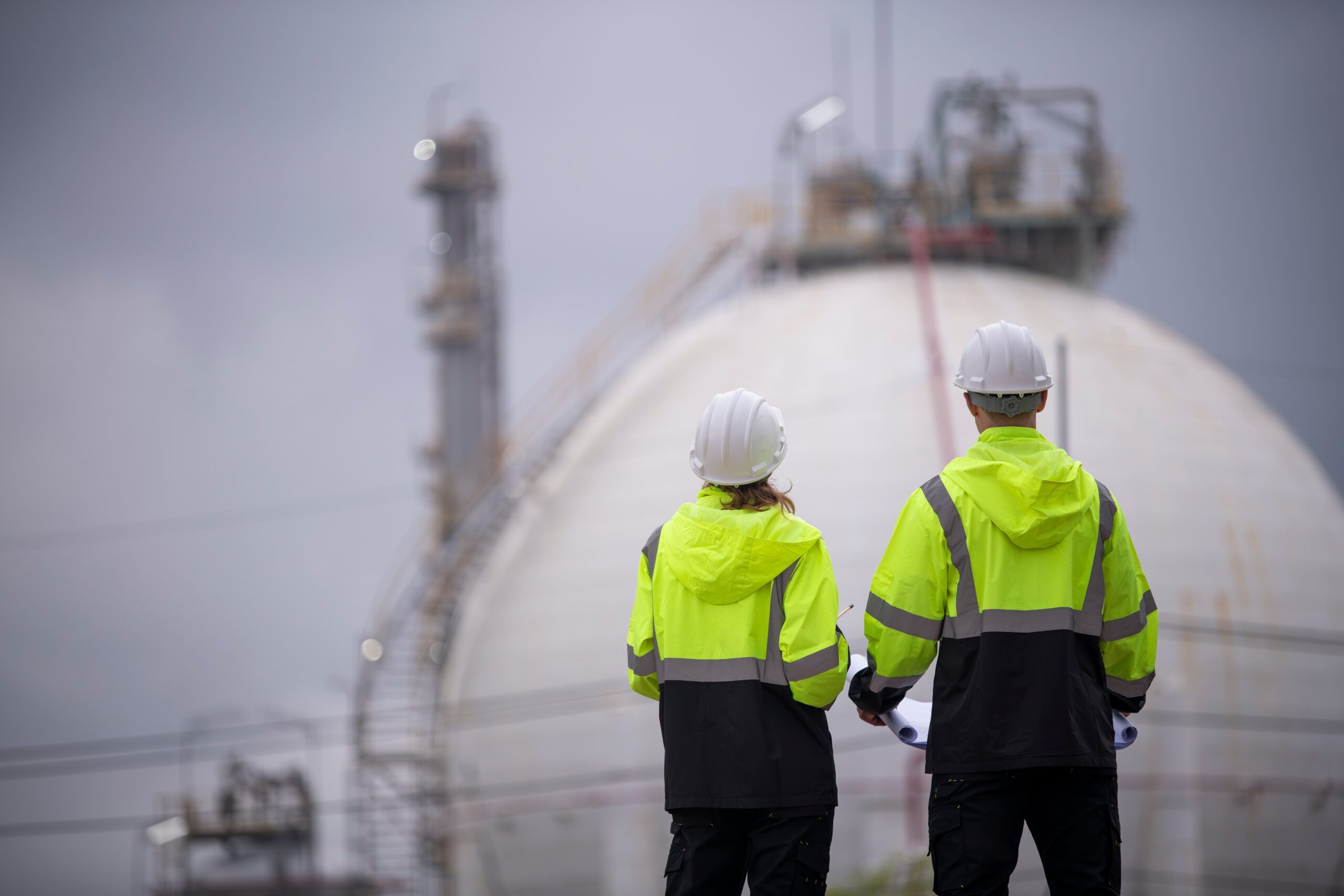 Engineers,Wearing,Safety,Gear,,Including,Hard,Hats,Examining,Survey,A